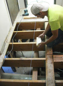 Leveling joists to eliminate a hump