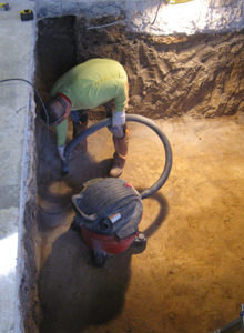 Vacuuming pit floor.