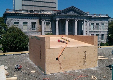 Plywood added to the exterior of the elevator shaft.