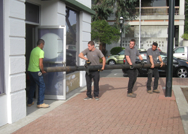 The elevator's cylinder is carried into the building.