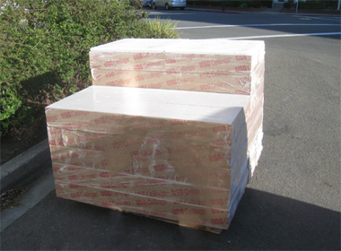 Acoustical ceiling tiles arrive on a pallet.