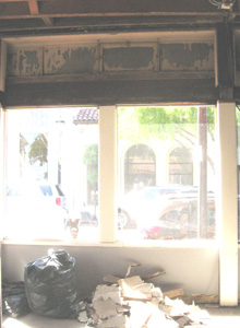 Original transom windows exposed by interior demolition work.