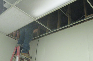 Installing 2x4s for a fire wall in the ceiling crawlspace.