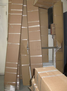 Boxes containing the new storefront doors at the contractor’s warehouse.