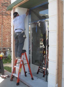 Final mirror finish stainless steel storefront being installed.