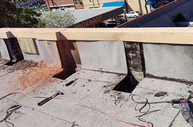 Holes cut in the roof to allow the installation of steel columns.