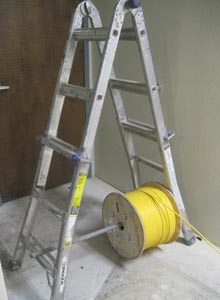 Yellow cable for security cameras is taken off the spool.