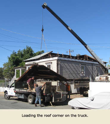 To move the house, a part of the roof is loaded on a Trost Jacking and Heavy Moving truck.