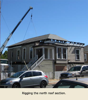 The crane gets ready to lift another part of the roof during the house moving in Martinez, California.