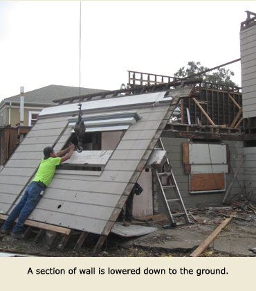 As a part of moving the house, a section of wall is lowered.