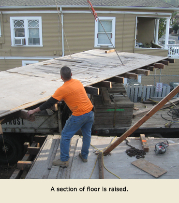 House Moving by Trost: A section of floor is lifted.